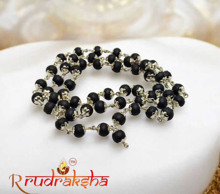 Karungali beaded necklace on a white stone with 'R Rudraksha' branding. lab Certified German Silver Mala 54 Beads