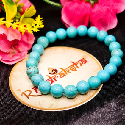 Turquoise beaded bracelet Lab Tested Authentic product on a decorative plate with flowers in the background