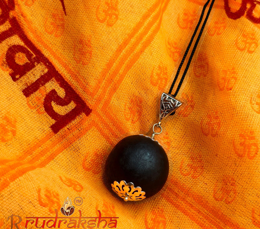 Karungali pendant necklace on a yellow fabric background with ' R Rudraksha' branding. Lab Tested Authentic product 