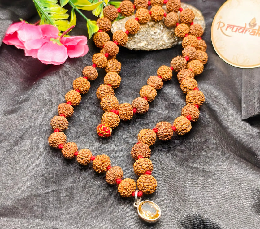 A Mala made up with 27 Beads of 7 Mukhi, 7 beads of 8 Mukhi with a citrine Pendant in center 