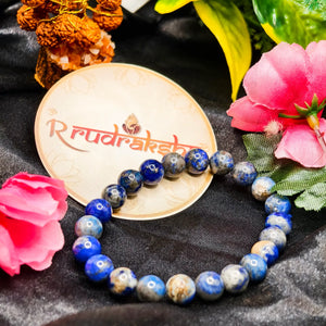 Blue lapis lazuli bracelet Lab Certified lab beaded bracelet on a black fabric background with 'R Rudraksh' branding.vrat. Lajvrat Bracelet 