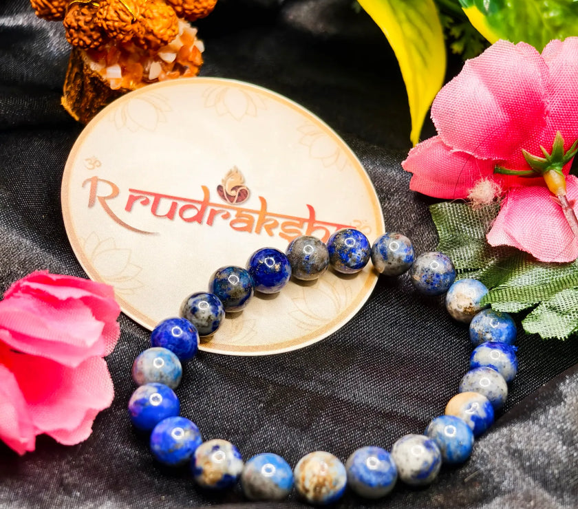 Blue lapis lazuli bracelet Lab Certified lab beaded bracelet on a black fabric background with 'R Rudraksh' branding.vrat. Lajvrat Bracelet 