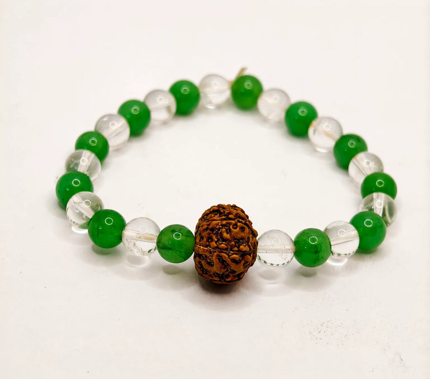 Bracelet with green and clear beads and a brown rudraksha stone on a white background