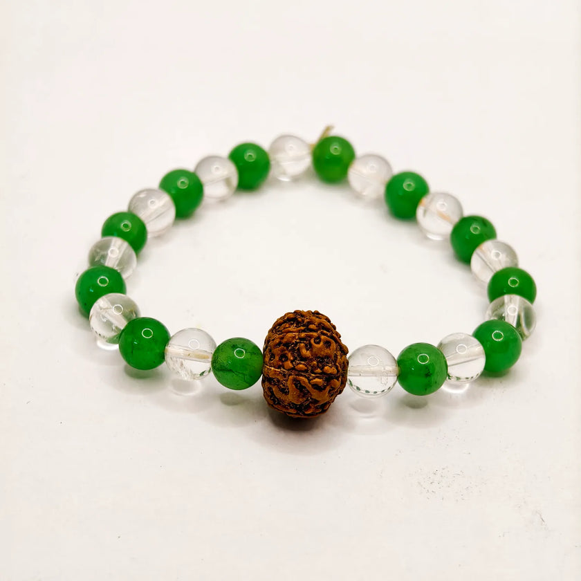 Bracelet with green and clear beads and a brown rudraksha stone on a white background