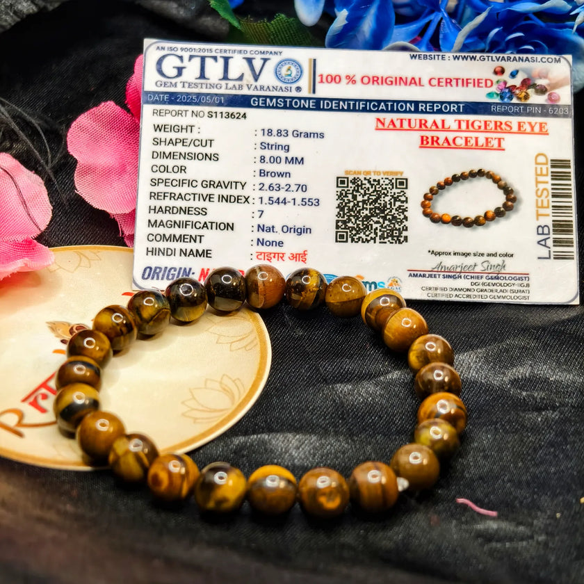 Lab Tested Tiger eye bracelet with a GTLV certification card on a textured surface.