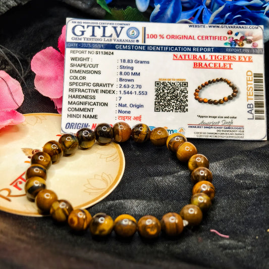 Lab Tested Tiger eye bracelet with a GTLV certification card on a textured surface.